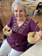 trudy resident at Aravilla Clearwater Memory Care Community Trudy offering loved staff root beer floats